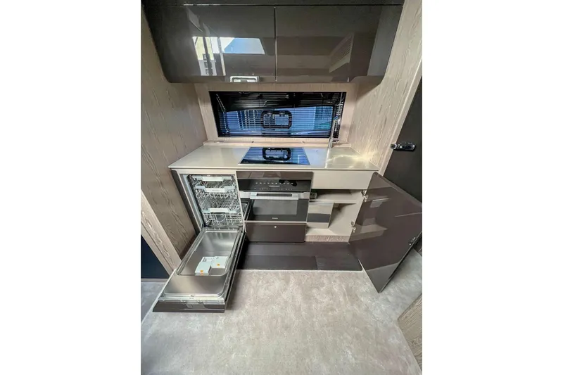  Yacht Photos Pics Modern kitchen in 2024 Azimut Atlantis 51 yacht with open dishwasher and sleek cabinetry.