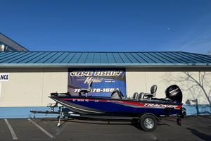 2017 Tracker Pro Team 175 TF boat on trailer, parked outside a building.