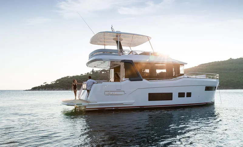  Yacht Photos Pics 2025 Sirena 48 yacht on serene water at sunset, featuring modern design and spacious deck.