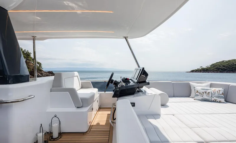 Yacht Photos Pics Luxurious 2025 Sirena 48 yacht interior with modern helm and seating, overlooking serene ocean view.
