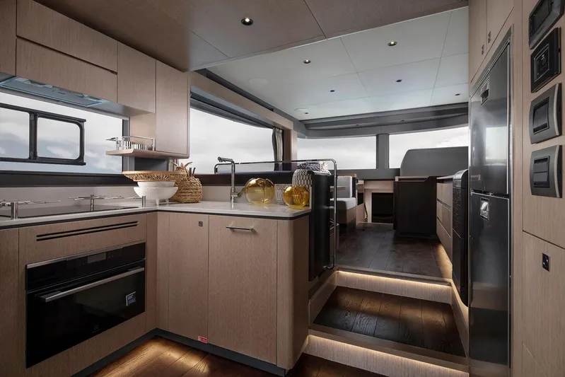  Yacht Photos Pics Luxurious interior of 2025 Sirena 48 yacht featuring modern kitchen and dining area.