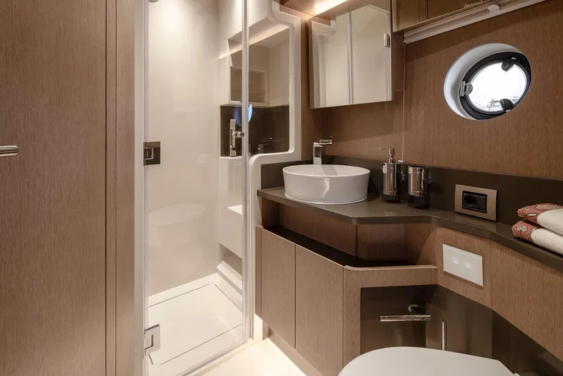  Yacht Photos Pics Luxurious bathroom in 2025 Sirena 48 yacht with modern fixtures and elegant wood finishes.