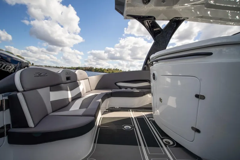  Yacht Photos Pics Luxurious 2020 MTI V42 boat interior with sleek seating and modern design under a blue sky.