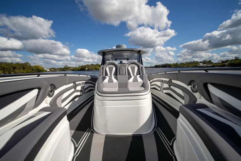  Yacht Photos Pics Luxury MTI V42 boat interior with sleek seating, under a bright blue sky.