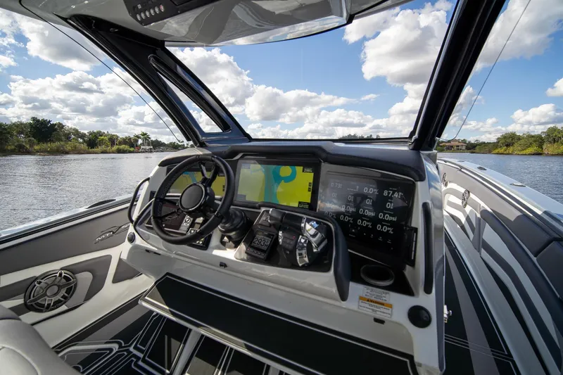  Yacht Photos Pics Cockpit view of 2020 MTI V42 boat with advanced navigation system and scenic waterway.