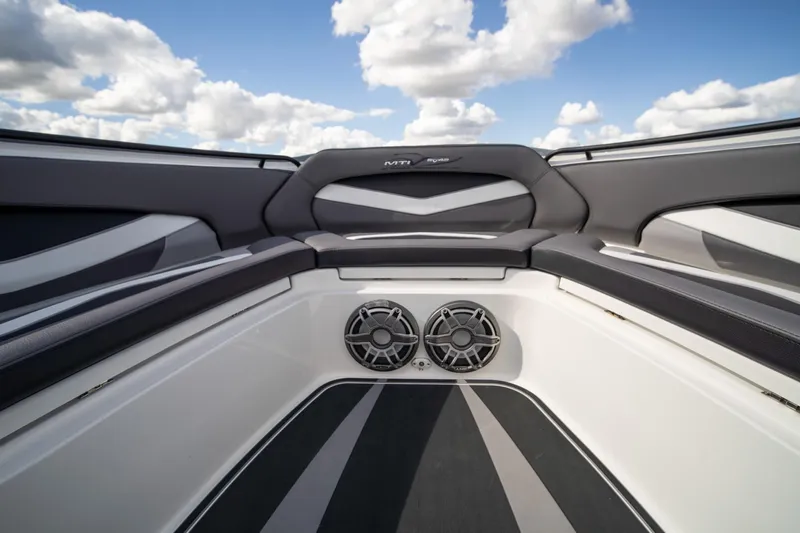  Yacht Photos Pics Interior of 2020 MTI V42 boat with sleek seating and dual speakers under a blue sky.
