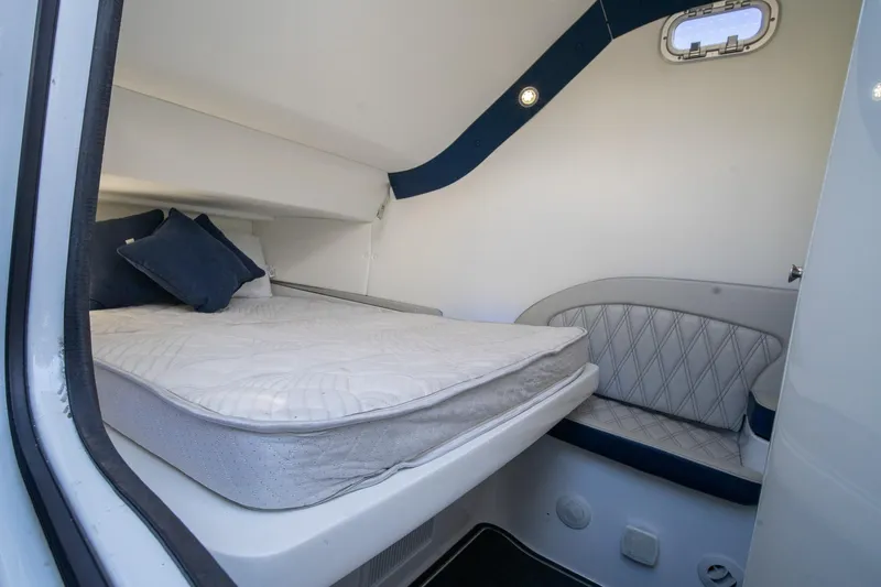 Yacht Photos Pics 2020 MTI V42 cabin interior with bed, cushions, and seating area.