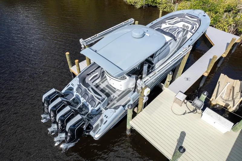  Yacht Photos Pics Aerial view of 2020 MTI V42 boat docked, featuring sleek design and multiple outboard engines.