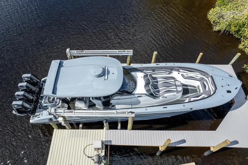  Yacht Photos Pics Aerial view of a 2020 MTI V42 boat docked, featuring sleek design and multiple engines.