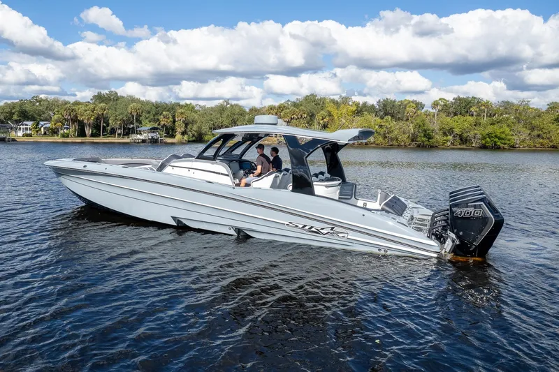  Yacht Photos Pics 2020 MTI V42 boat on a calm river with lush green shoreline.