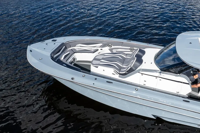  Yacht Photos Pics 2020 MTI V42 boat with sleek design and spacious seating on calm water.