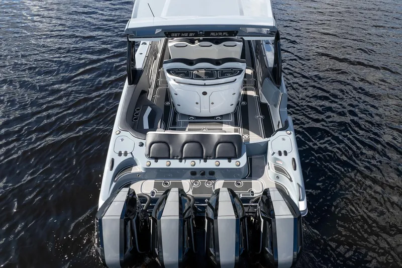  Yacht Photos Pics 2020 MTI V42 boat with four engines on calm water, showcasing sleek design and spacious seating.
