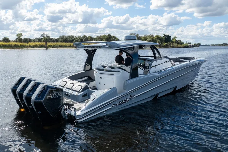  Yacht Photos Pics 2020 MTI V42 boat with quad engines cruising on a scenic lake.
