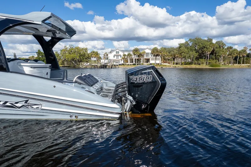  Yacht Photos Pics Luxury MTI V42 boat with powerful outboard engine on scenic waterfront.