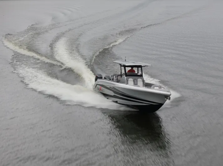  Yacht Photos Pics 2025 Donzi 39 VRZ speedboat cruising on open water, creating dynamic wake patterns.