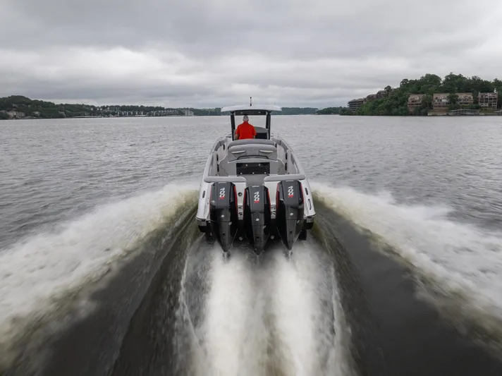  Yacht Photos Pics 2025 Donzi 39 VRZ speedboat cruising on a lake with powerful engines.