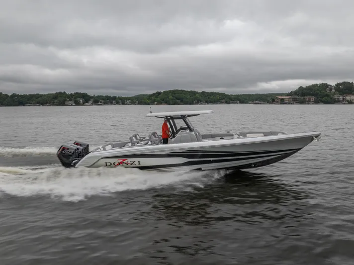  Yacht Photos Pics 2025 Donzi 39 VRZ speedboat cruising on a lake under cloudy skies.