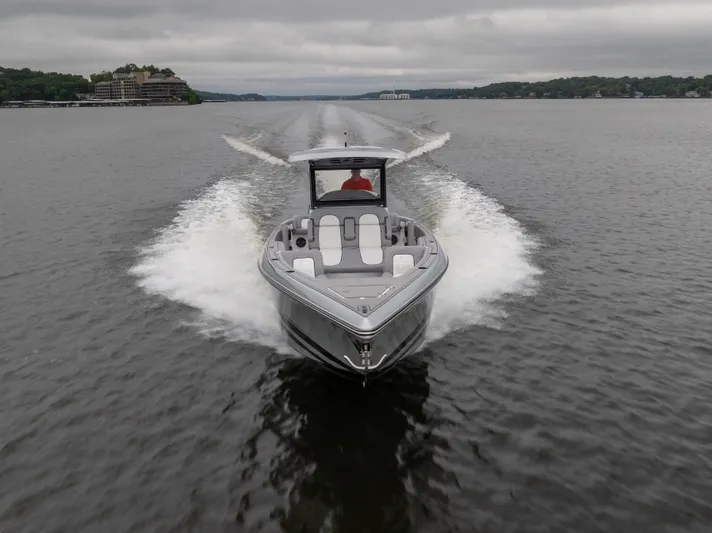  Yacht Photos Pics 2025 Donzi 39 VRZ speedboat cruising on a lake under cloudy skies.