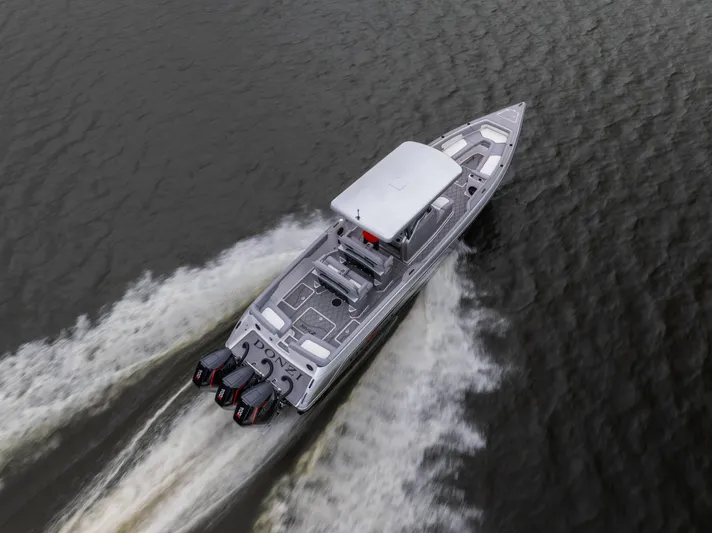  Yacht Photos Pics 2025 Donzi 39 VRZ boat cruising on water with triple outboard engines.