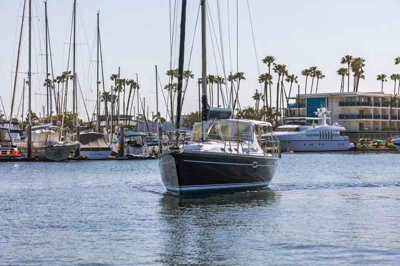 Blue Moon Yacht Photos Pics Catalina 400 MkII sailboat from 2004 navigating a marina with palm trees and yachts.