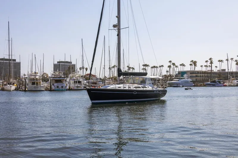 Blue Moon Yacht Photos Pics Sailboat Catalina 400 MkII 2004 in marina with palm trees and yachts in background.