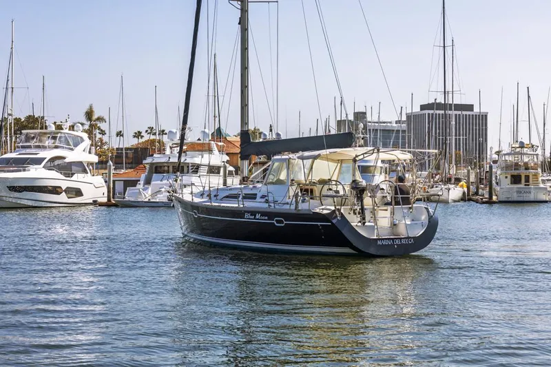 Blue Moon Yacht Photos Pics 2004 Catalina 400 MkII sailboat docked in a marina with other boats.