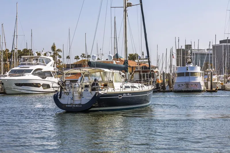 Blue Moon Yacht Photos Pics 2004 Catalina 400 MkII sailboat docked in a marina with other boats.
