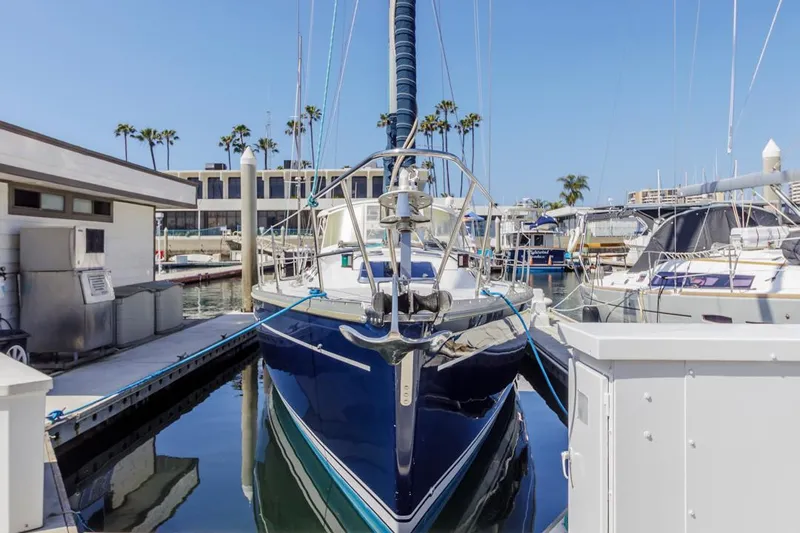 Blue Moon Yacht Photos Pics Catalina 400 MkII sailboat docked in marina, 2004 model, clear blue sky, palm trees in background.