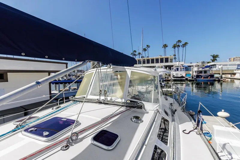 Blue Moon Yacht Photos Pics 2004 Catalina 400 MkII sailboat docked in a marina under clear blue skies.