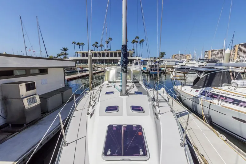 Blue Moon Yacht Photos Pics 2004 Catalina 400 MkII sailboat docked in a sunny marina, surrounded by other boats.