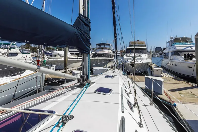 Blue Moon Yacht Photos Pics 2004 Catalina 400 MkII sailboat docked among other yachts in a marina under clear blue skies.