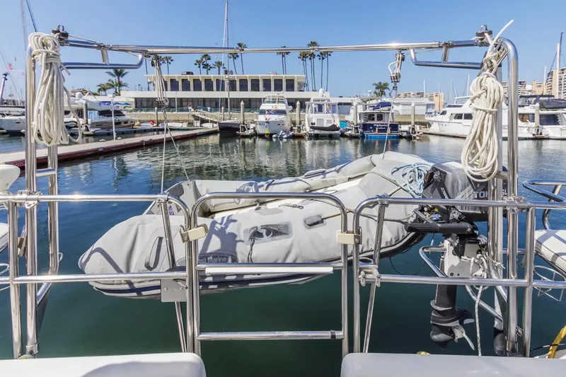 Blue Moon Yacht Photos Pics Catalina 400 MkII sailboat at marina with dinghy, 2004 model, sunny day, palm trees in background.