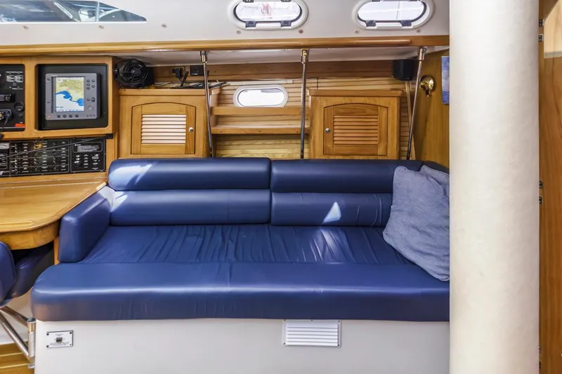 Blue Moon Yacht Photos Pics Interior of 2004 Catalina 400 MkII sailboat with blue seating and navigation equipment.