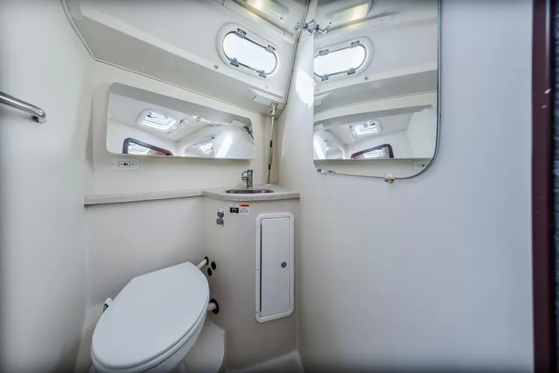 Blue Moon Yacht Photos Pics 2004 Catalina 400 MkII yacht bathroom with toilet, sink, mirrors, and portholes.