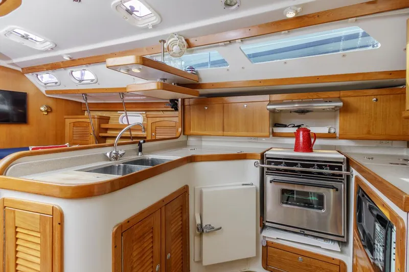 Blue Moon Yacht Photos Pics 2004 Catalina 400 MkII yacht kitchen with wood cabinetry, stainless steel appliances, and skylights.