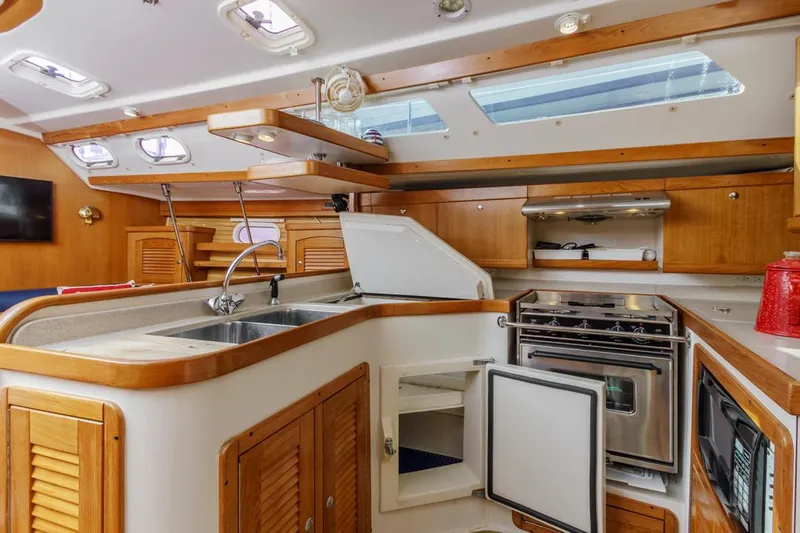 Blue Moon Yacht Photos Pics Interior of 2004 Catalina 400 MkII yacht kitchen with wood cabinetry and modern appliances.