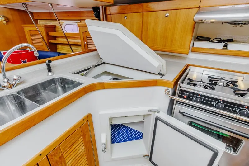 Blue Moon Yacht Photos Pics 2004 Catalina 400 MkII yacht kitchen with stove, sink, and storage compartments.