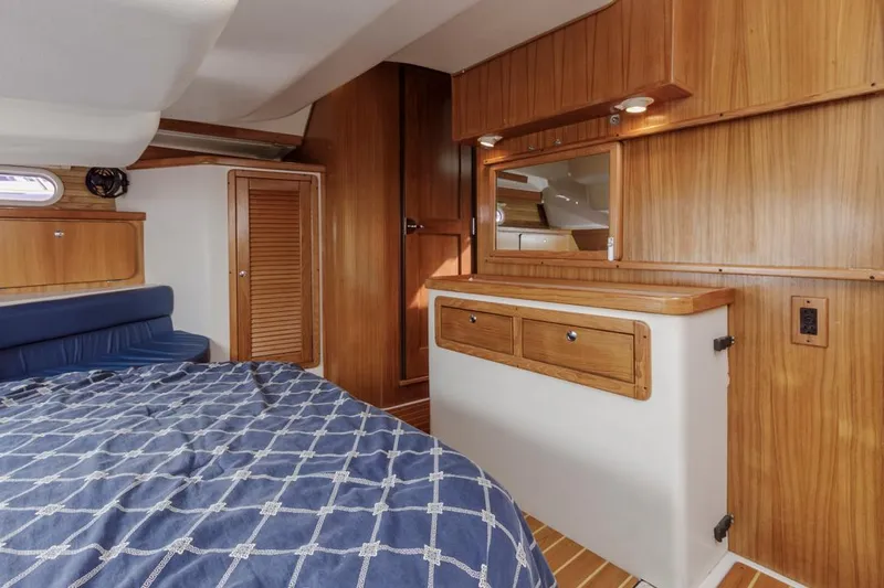 Blue Moon Yacht Photos Pics Interior of 2004 Catalina 400 MkII yacht with wooden cabinetry and blue bedding.