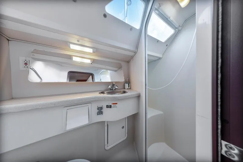 Blue Moon Yacht Photos Pics 2004 Catalina 400 MkII yacht bathroom with sink, mirror, and shower area.