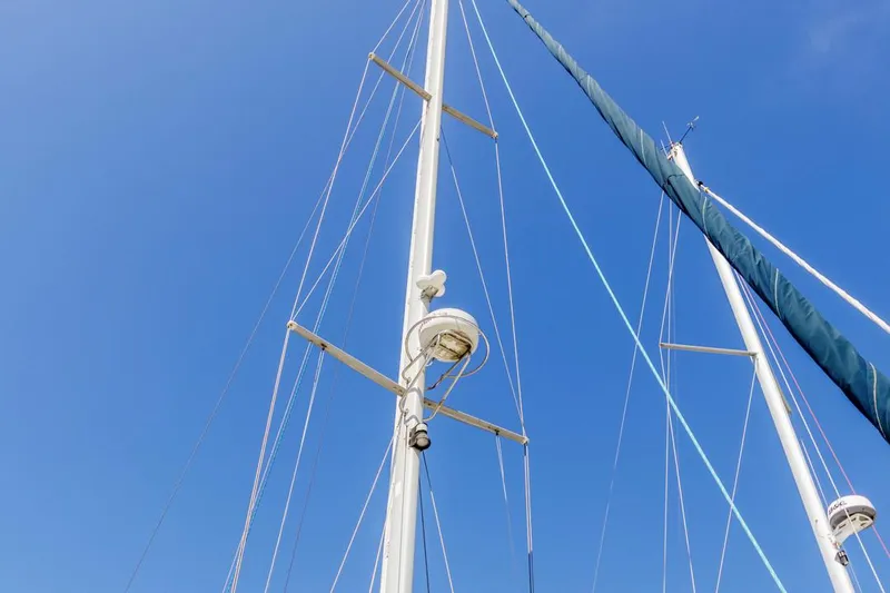 Blue Moon Yacht Photos Pics Mast of 2004 Catalina 400 MkII sailboat against clear blue sky.