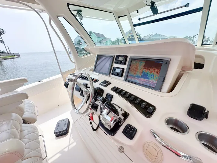  Yacht Photos Pics Helm of 2011 Grady-White 366 Canyon with 2020 Suzuki engines, featuring advanced navigation systems.