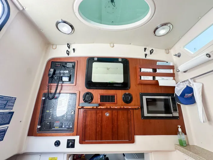  Yacht Photos Pics Grady-White 366 Canyon 2011 interior with control panel, microwave, and storage.