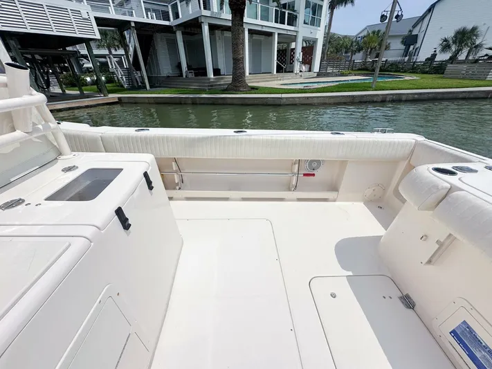  Yacht Photos Pics Grady-White 366 Canyon 2011 boat deck with 2020 Suzuki engines, docked by waterfront homes.