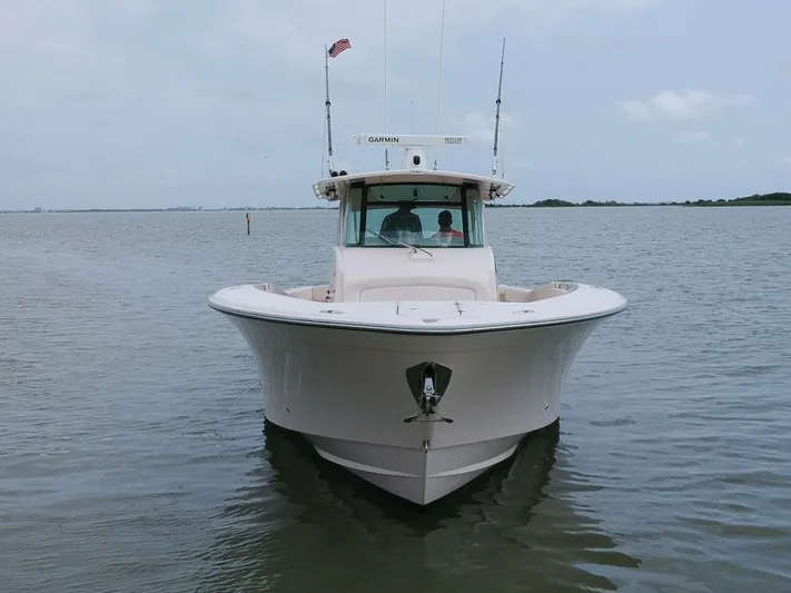  Yacht Photos Pics Grady-White 366 Canyon boat with 2020 Suzuki engines on calm water, front view.