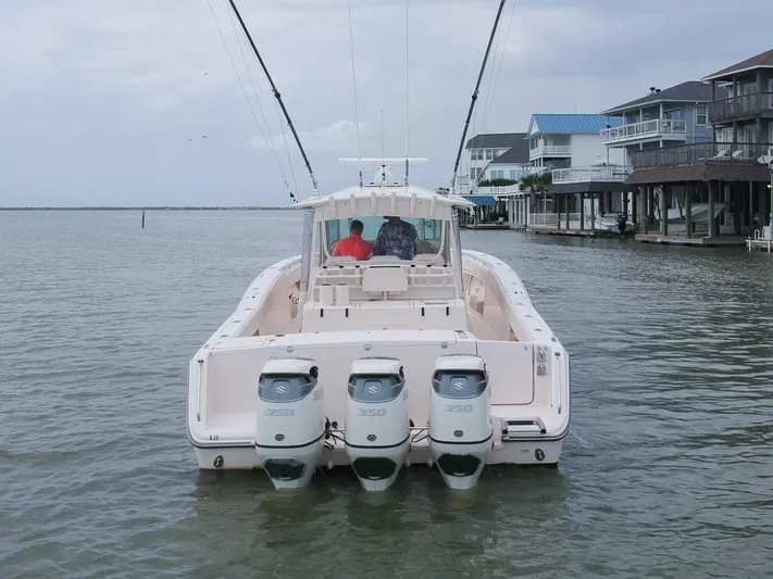 Yacht Photos Pics Grady-White 366 Canyon boat with 2020 Suzuki engines, docked near waterfront homes.