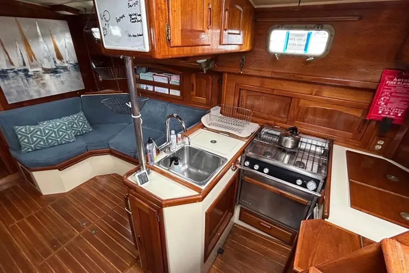 Kai Mana Yacht Photos Pics Cozy 1990 Pacific Seacraft PSC 37 yacht interior with kitchen and seating area.