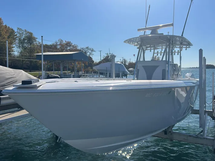  Yacht Photos Pics 2022 Contender 35 ST boat docked in a marina under clear skies.