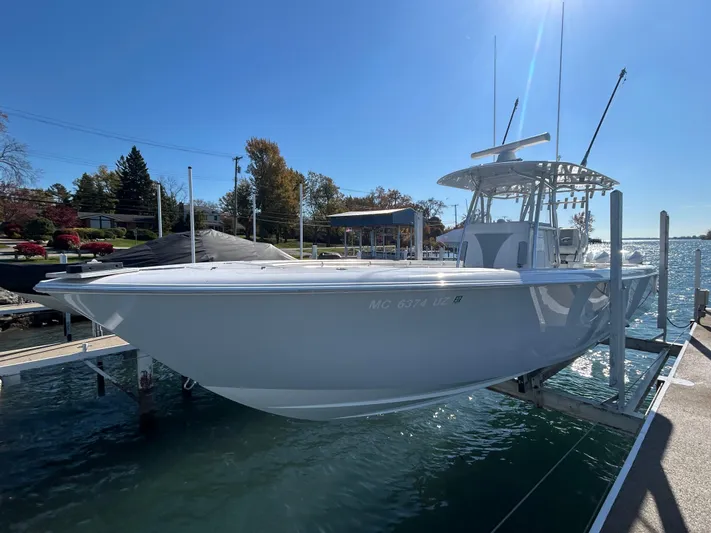  Yacht Photos Pics 2022 Contender 35 ST boat docked on a sunny day, showcasing sleek design and modern features.