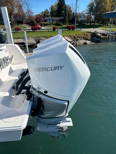  Yacht Photos Pics 2022 Contender 35 ST boat with Mercury outboard motor on a calm lake.