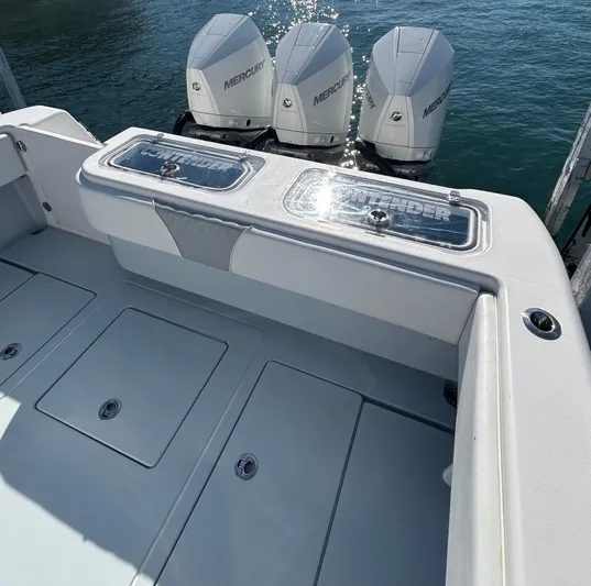  Yacht Photos Pics 2022 Contender 35 ST boat with triple Mercury engines on calm water.